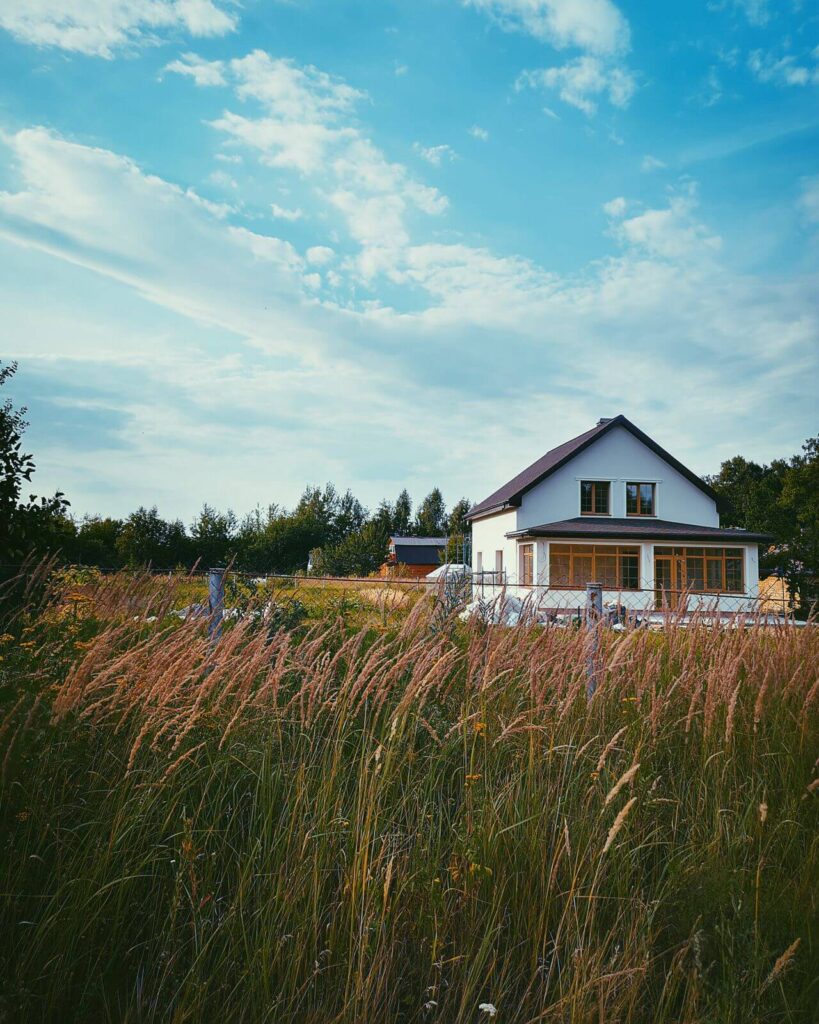 Exterior view of a 480 sq ft backyard cottage and detached ADU in Wheat Ridge, Colorado set against a bright blue sky.