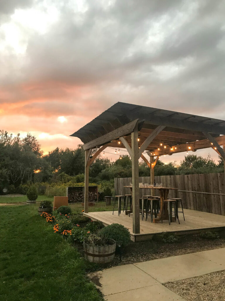Custom wooden deck, pergola, and outdoor bar seating in a Colorado backyard ADU design inspiration gallery.