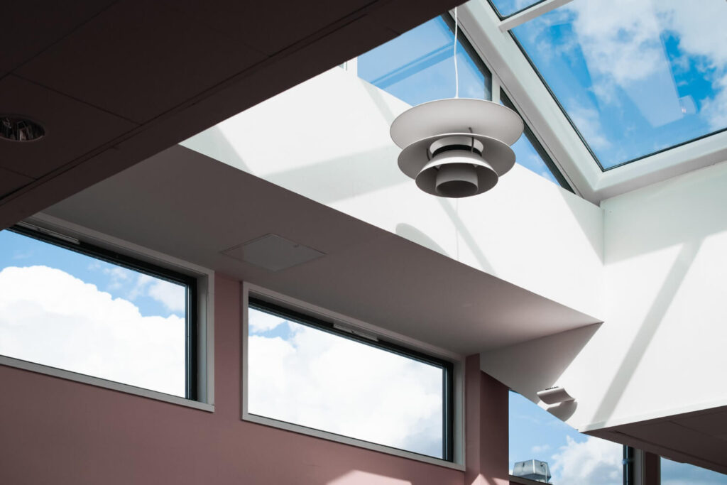Interior view of skylights, light wells, and large windows bringing natural sunlight into a below-grade basement accessory dwelling unit.